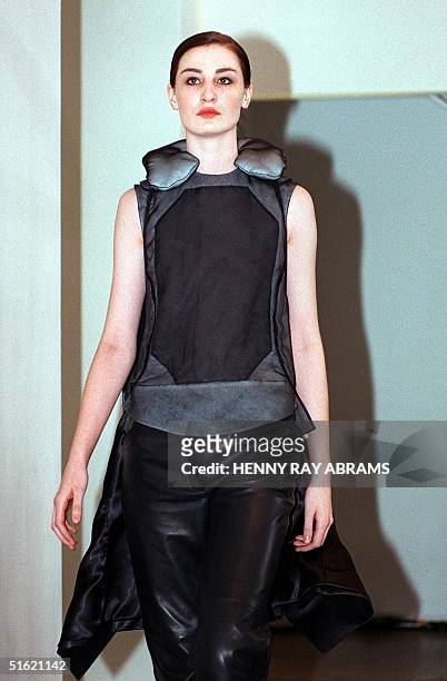 Model wears a silk organza body vest with black silk organza neck rest, black leather pants and a black leather coat during the Helmut Lang fashion...