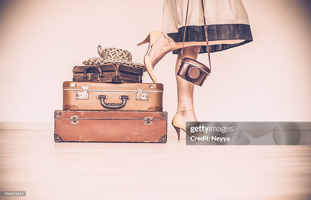 Woman standing beside suitcases