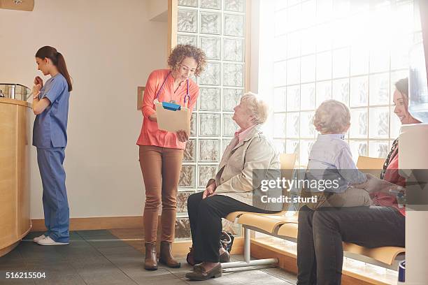 clinic visit for senior woman - waiting room clinic stock pictures, royalty-free photos & images