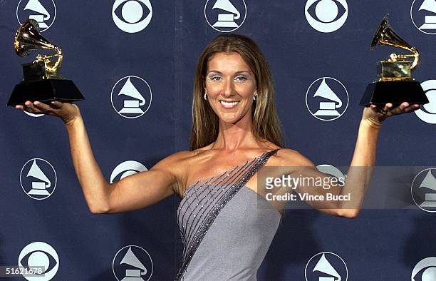 Canadian singer Celine Dion poses with her Grammy Awards at the Shrine Auditorium in Los Angeles 24 February. Dion won awards for "Record of the...