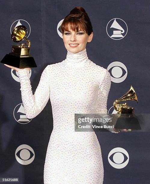 Country music star Shania Twain poses with her two Grammys for Best Country Song and Best Female Country Vocal Performance at the 41st Annual Grammy...