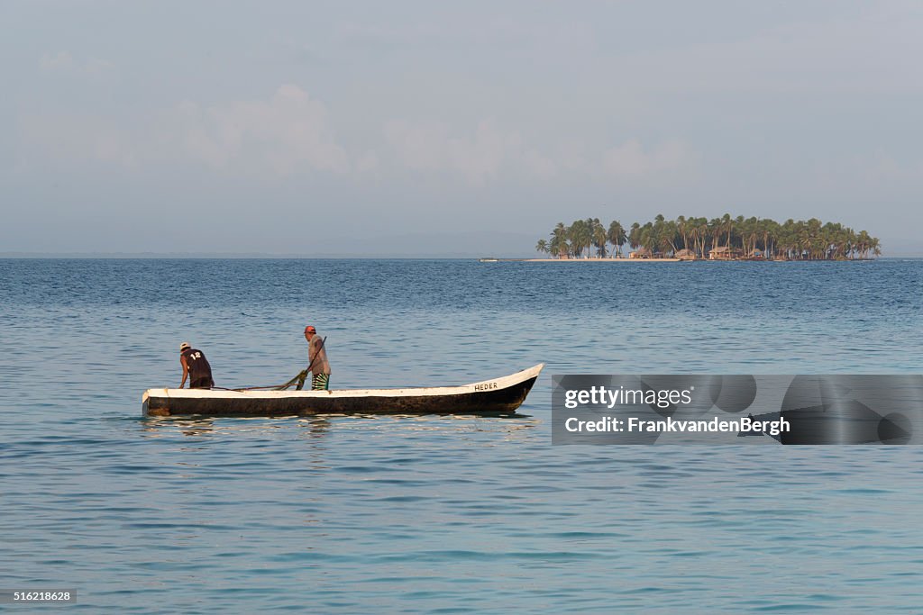 Two men in wooden canoe