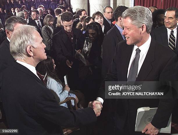President Bill Clinton is greeted by former US Senator Bob Packwood at the conclusion of a memorial service for former Governor of Florida and former...