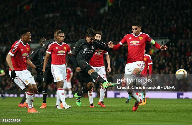 Chris Smalling of Manchester United attempts to block the shot of Roberto Firmino of Liverpool during the UEFA Europa League round of 16 second leg...