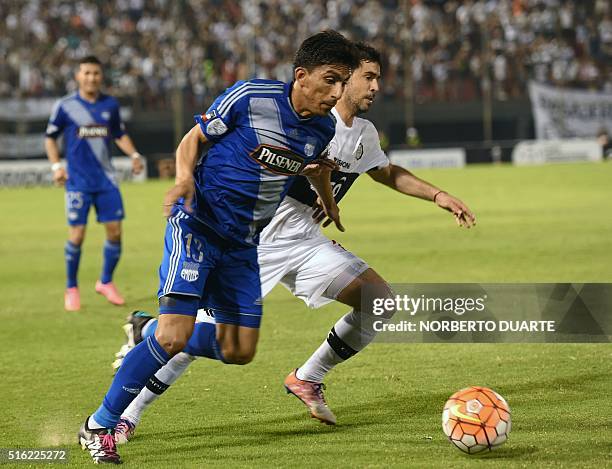 Angel Mena of Ecuador's Emelec vies for the ball with Julian Benitez of Paraguay's Olimpia during their Libertadores 2016 Cup football match at...