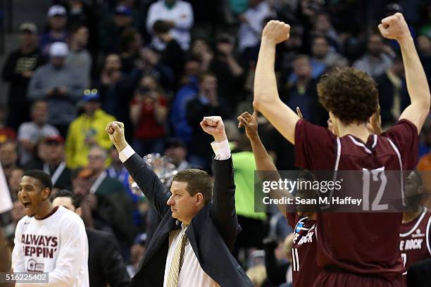 Members of the Arkansas Little Rock Trojans celebrate after defeating the Purdue Boilermakers 85-83 in double overtime during the first round of the...