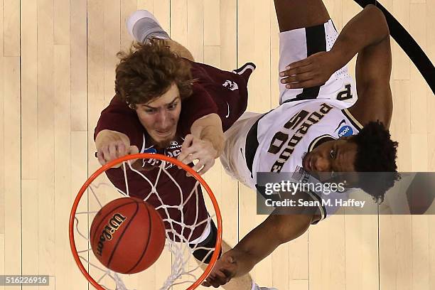 Lis Shoshi of the Arkansas Little Rock Trojans dunks the ball over Caleb Swanigan of the Purdue Boilermakers during the first round of the 2016 NCAA...