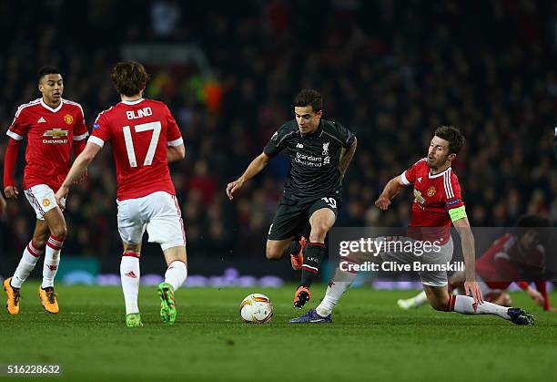 Philippe Coutinho of Liverpool takes on Jesse Lingard, Daley Blind and Michael Carrick of Manchester United during the UEFA Europa League round of 16...