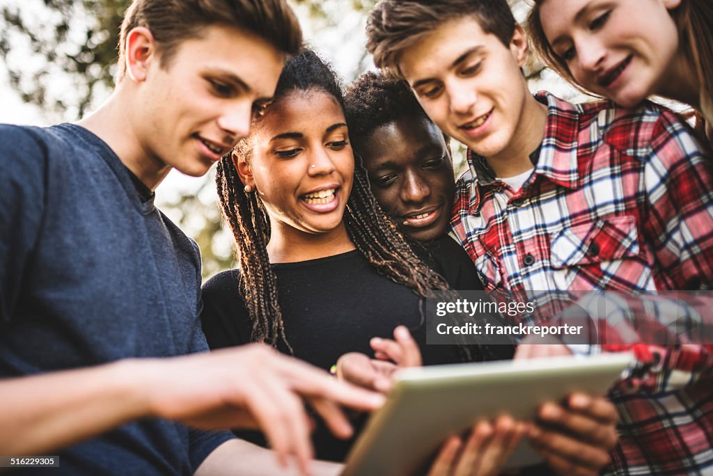 Group of college student using the tablet togetherness