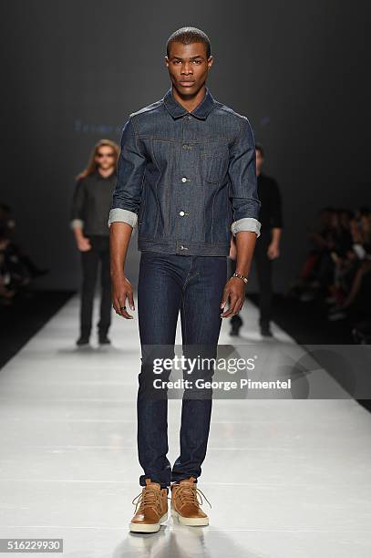 Model walks the runway wearing Triarchy 2016 collection during Toronto Fashion Week Fall 2016 at David Pecaut Square on March 17, 2016 in Toronto,...