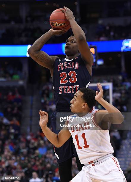 Fresno State Bulldogs guard Marvelle Harris takes a shot over Utah Utes guard Brandon Taylor in the first half during the first round of the men's...