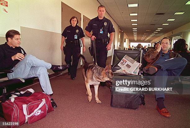 Los Angeles Police Department Bomb Squad Detection k-9 Unit members Officers Pat Guessferd and Harry Wuzellrd patrol with "Brenda" at Los Angeles...