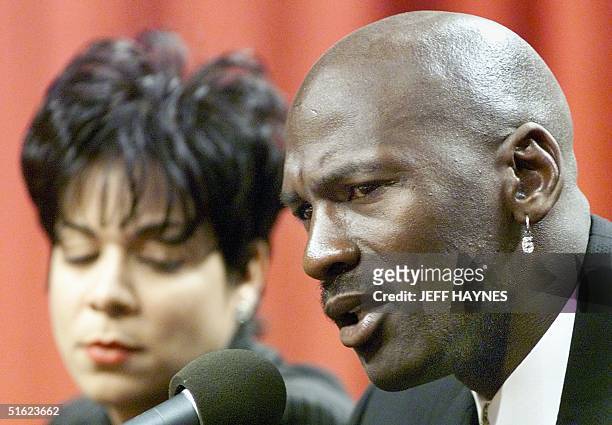 Michael Jordan of the Chicago Bulls sits with his wife Juanita as he speaks at his press conference 13 January to announce he is retiring from the...
