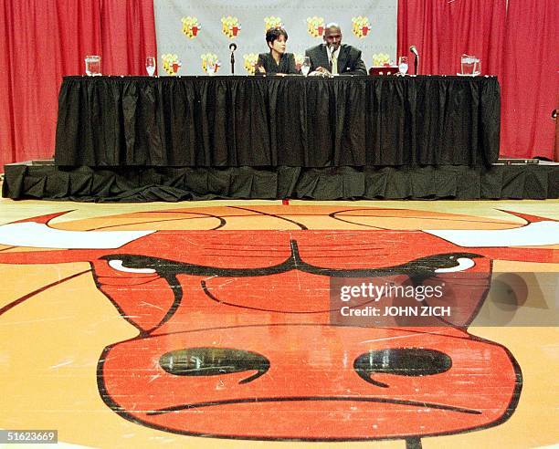 Michael Jordan of the Chicago Bulls sits with his wife Juanita as he speaks at his press conference from center court at the United Center in...