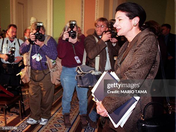 Sen. Olympia Snowe makes her way past photographers as she leaves the Senate chamber at the end of the second session of the impeachment trial of US...