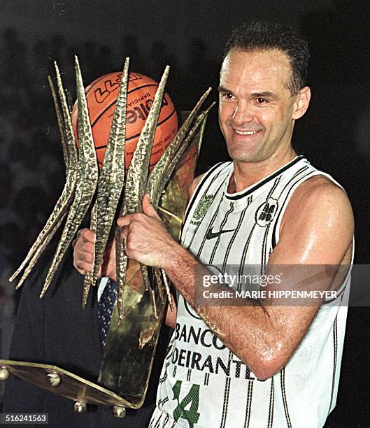 Brazilian basketball player Oscar Schmidt holds a trophy 15 March in Barueri, Brazil for his 22 years of professional play.The Brazilian basketball...