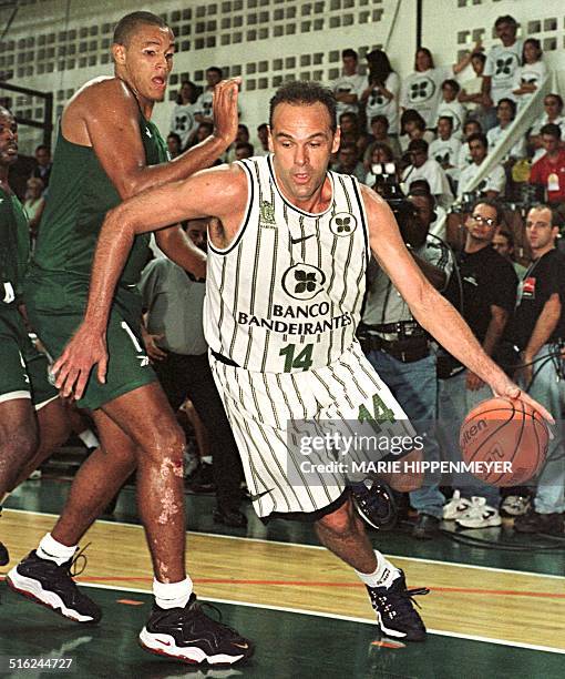 Brazilian basketball star Oscar Schmidt of Banco Bandeirantes drives to the basket against Palmeires in which he scored this 40,000th career point 15...