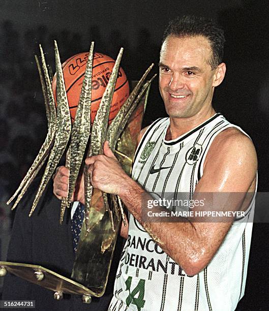 Brazilian basketball player Oscar Schmidt holds a trophy 15 March in Barueri, Brazil for his 22 years of professional play.The Brazilian basketball...