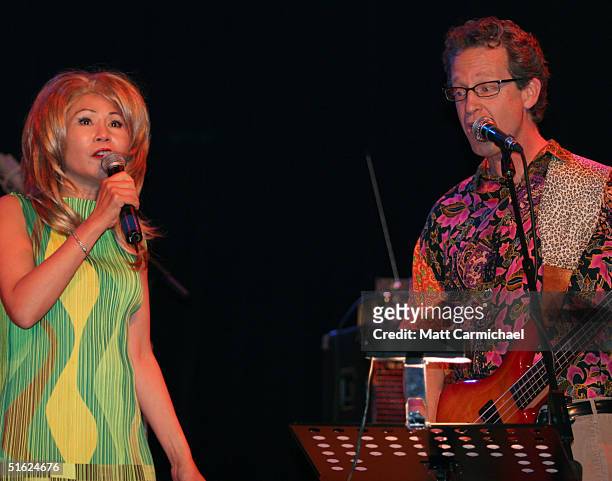 Amy Tan and Ridley Pearson perform with The Rock Bottom Remainders at Chicago's House of Blues on October 28, 2004 in Chicago, Illinois.