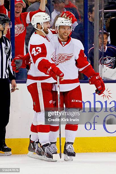 Darren Helm of the Detroit Red Wings is congratulated by Luke Glendening of the Detroit Red Wings after scoring a goal during the third period of the...