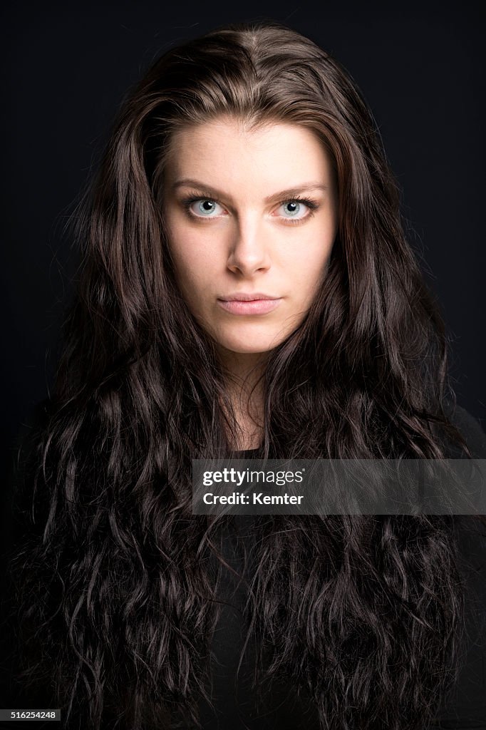 Beautiful young woman with long brown hair portrait