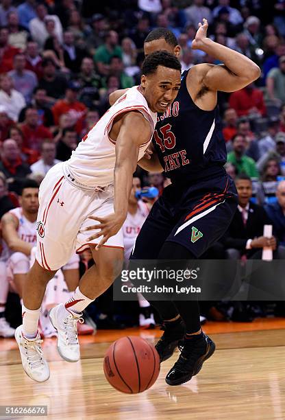 Utah Utes guard Brandon Taylor gets fouled by Fresno State Bulldogs guard Lionel Ellison III as he drives to the basket in the second half during the...