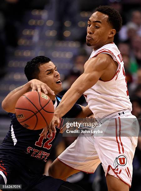 Fresno State Bulldogs guard Cezar Guerrero gets the ball knocked away by Utah Utes guard Brandon Taylor in the second half during the first round of...