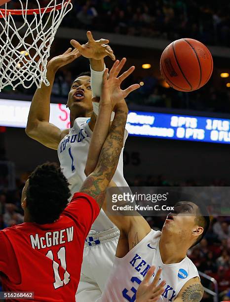 Derek Willis and Skal Labissiere of the Kentucky Wildcats reject a shot by Rayshaun McGrew of the Stony Brook Seawolves in the first half during the...