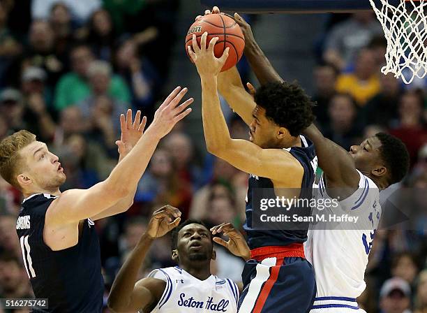 Silas Melson of the Gonzaga Bulldogs rebounds against Derrick Gordon and Michael Nzei of the Seton Hall Pirates in the first half during the first...