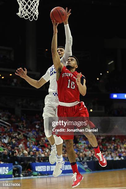 Jamal Murray of the Kentucky Wildcats blocks a shot by Carson Puriefoy of the Stony Brook Seawolves in the second half during the first round of the...