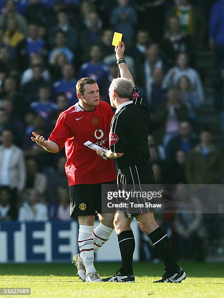 Wayne Rooney of Manchester gets a yellow card from referee Neil Barry during the Barclays Premiership match between Portsmouth and Manchester United...