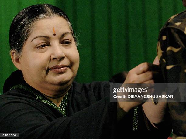 Chief Minister of the southern Indian state of Tamil Nadu, J.Jayalalithaa puts a medal on the uniform of a officer of the Special Task Force of the...