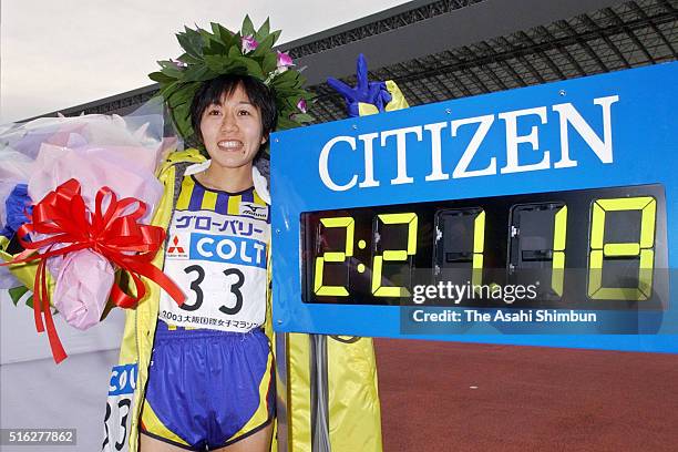 Mizuki Noguchi of Japan poses for photographs after the 22nd Osaka Women's Marathon at the Nagai Stadium on January 26, 2003 in Osaka, Japan.