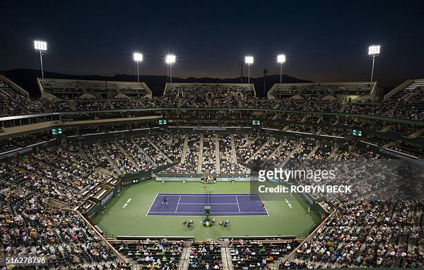 Milos Raonic of Canada returns a shot to Gael Monfils of France in the men's quarterfinals, March 17 at the BNP Paribas Open at the Indian Wells...