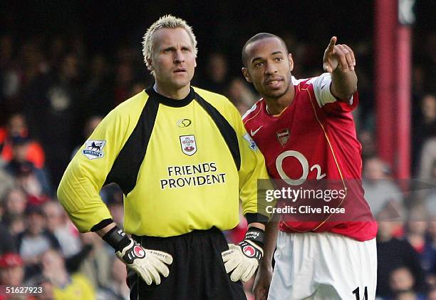 Thierry Henry of Arsenal explains the offside to Antti Niemi of Southampton during the Barclays Premiership match between Arsenal and Southampton at...