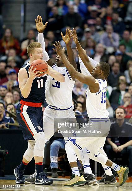 Isaiah Whitehead, Derrick Gordon and Angel Delgado of the Seton Hall Pirates defends against Domantas Sabonis of the Gonzaga Bulldogs in the second...