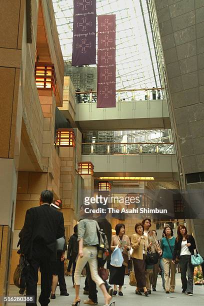 Visitors walk at the newly opened Roppongi Hills on April 25, 2003 in Tokyo, Japan.