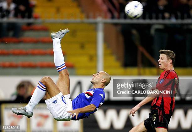 Italian Giulio Falcone of Sampdoria makes an overhead kick in front of AC Milan's John Dahl Tomasson during their Serie A football match at Luigi...