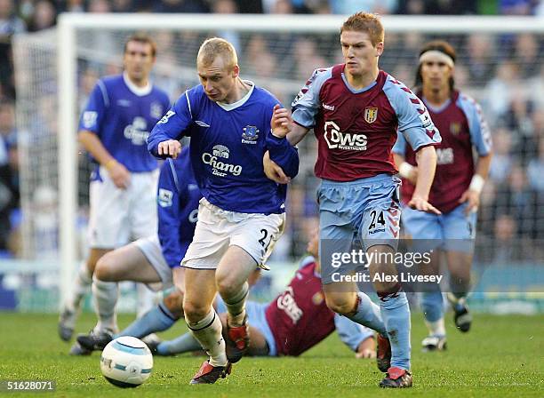 Tony Hibbert of Everton holds off a challenge from Steven Davis of Aston Villa during the Barclays Premiership match between Everton and Aston Villa...