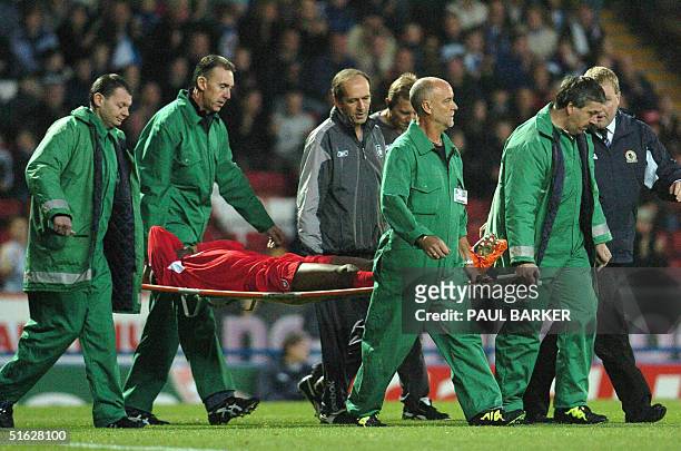 Liverpool's Djibril Cisse is taken off after breaking his leg at Blackburn during a Premier League football match at Ewood Park, Blackburn, United...