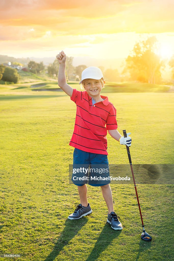 Young Boy Golfer Celebrating During Sunset