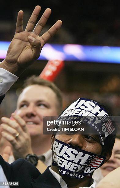 Supporter wears bumper stickers on his face during a speech by US President George W. Bush at campaign rally before 20,000 supporters at the Target...