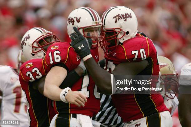 Quarterback Joel Statham of the University of Maryland Terrapins celebrates his 1-yard third quarter touchdown with Stephon Heyer and Josh Allen as...