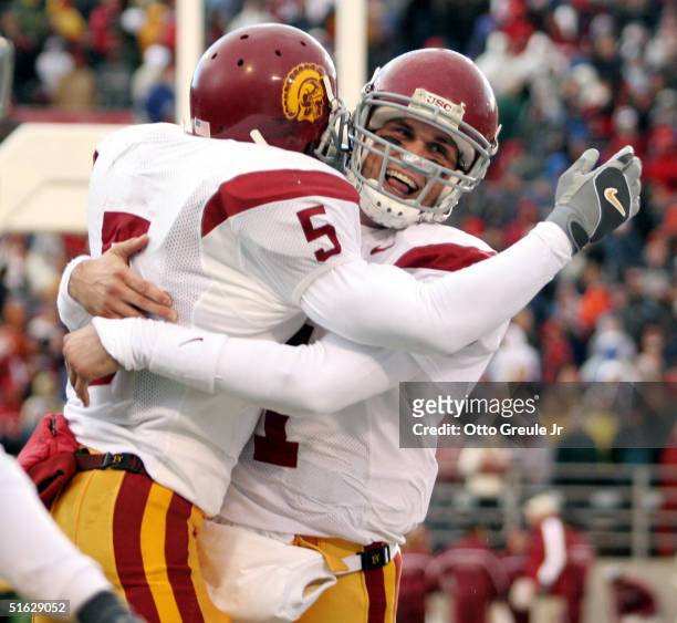 Running back Reggie Bush of the USC Trojans celebrates with quarterback Matt Leinart after scoring a touchdown against the Washington State Cougars...