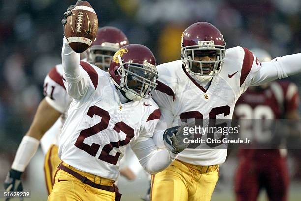 Running back Desmond Reed of the USC Trojans celebrates with safety Josh Pinkard after recovering a fumble on a kickoff against the Washington State...