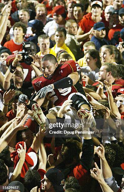 Sammy Maldonado of the Maryland Terrapins is passed above the crowd after they stormed the field after the Terrapins defeated the Florida State...