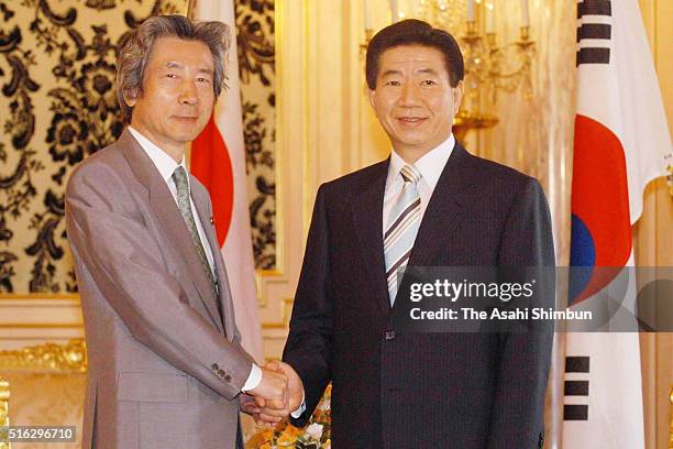 South Korean President Roh Moo Hyun and Japanese Prime Minister Junichiro Koizumi shake hands prior to their meeting at the Akasaka State Guesthouse...