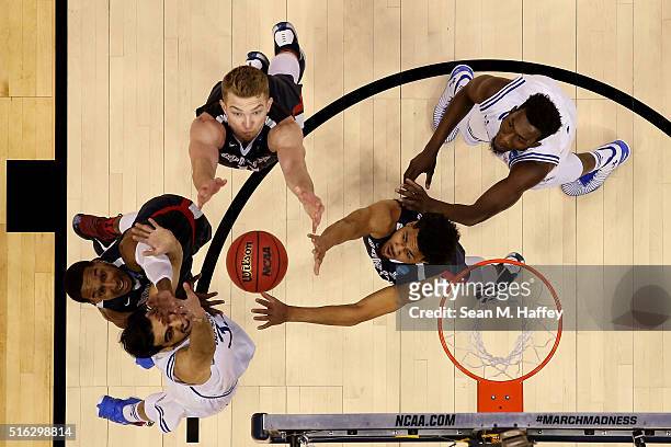 Eric McClellan, Silas Melson and Domantas Sabonis of the Gonzaga Bulldogs vie for a rebound with Derrick Gordon and Michael Nzei of the Seton Hall...