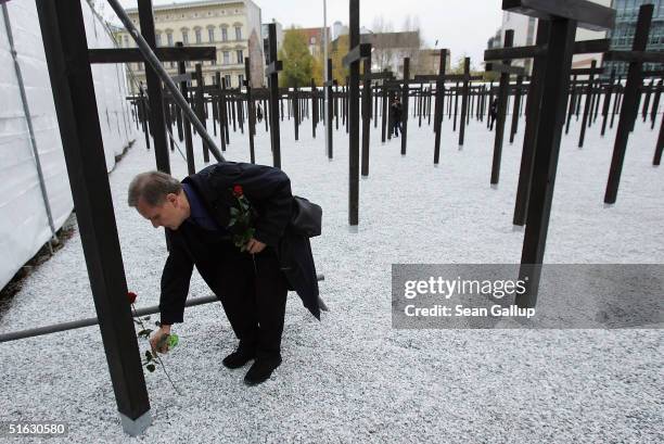 Ernst Piesche lays a rose at the cross commemorating his former friend Armin Brueckner during opening ceremonies of a new memorial of a rebuilt...
