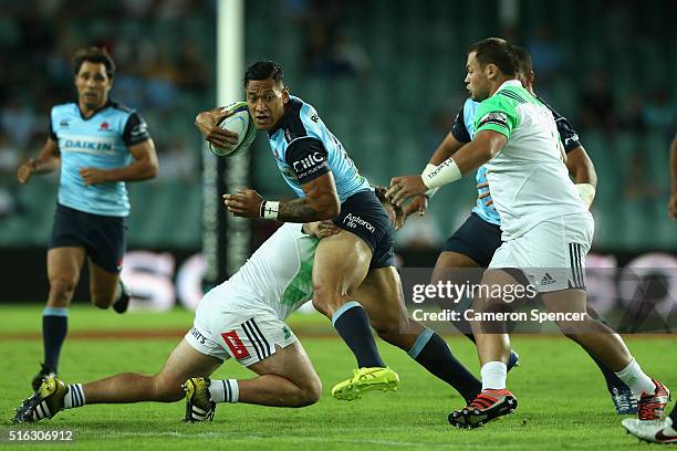 Israel Folau of the Waratahs is tackled during the Super Rugby match between the New South Wales Waratahs and the Highlanders at Allianz Stadium on...